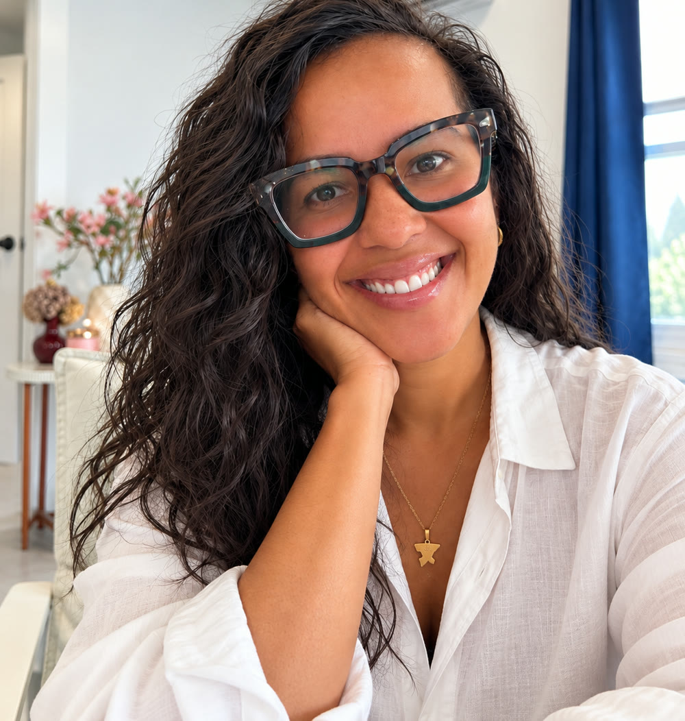 Indhira Santana smiling, resting her chin on her hand